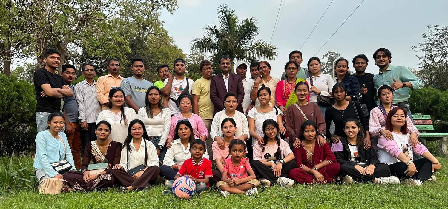 The Trishakti Apparel team and their families photographed together outdoors on a company day out