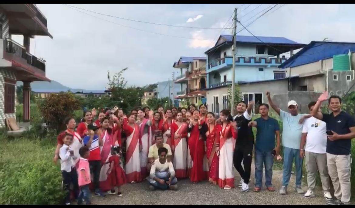 Trishakti Apparel staff celebrating Teej on the road outside the factory in Gaindakot, Nepal