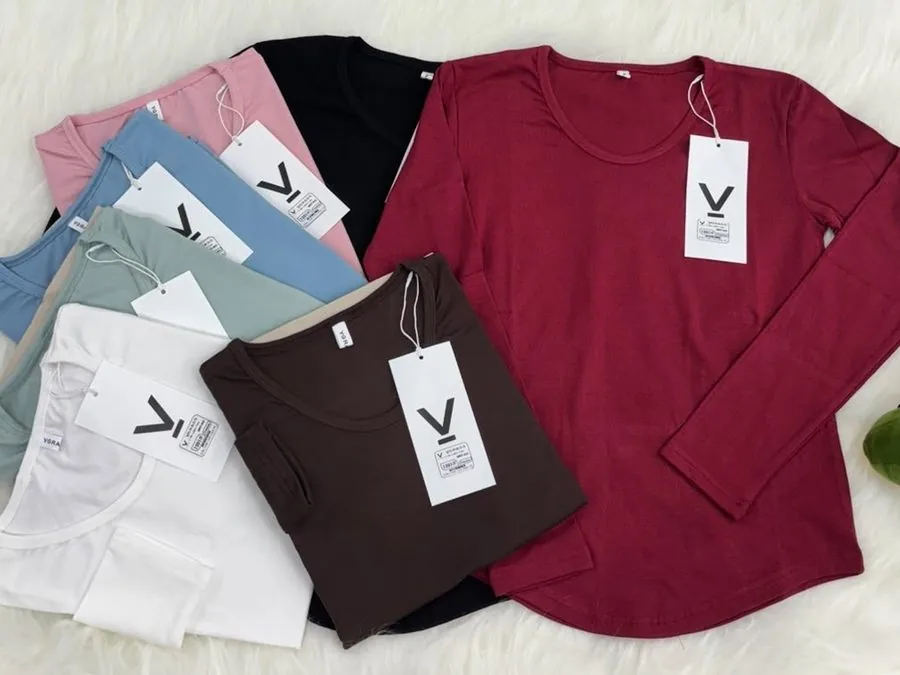 Long-sleeve knit tops in pastel and burgundy laid flat