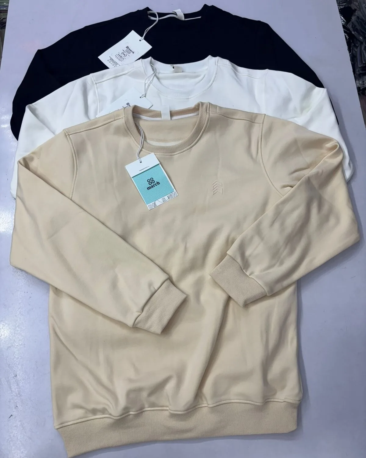Private-label ladies’ fleece sweatshirts in grey, cream, pink and black